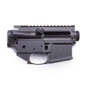 AR-15 style lower receiver with trigger guard and engraved logo, shown on a white background