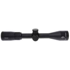 Black rifle scope with multiple adjustment dials and a large objective lens, designed for aiming at distant targets on a rifle.