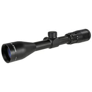 Black rifle scope with adjustable turrets and objective lens facing left sideing at an angle