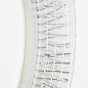 Clear curved transparent magazine for a toy/airsoft gun, showing grid-like texture and base at the bottom.