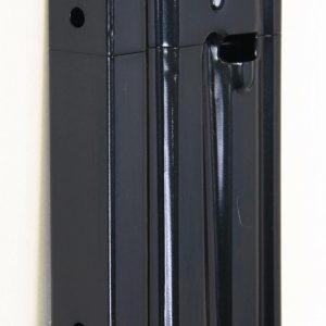 Black handgun magazine with a green follower, viewed from the side on a light background (informative image).