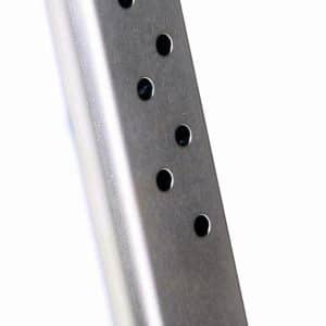Silver metal handgun magazine with evenly spaced circular holes, standing on a black base plate (informative image).