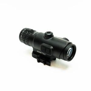 Black tactical rifle scope with mounting base and adjustment turrets on a white background.