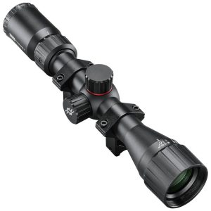 Black rifle scope with two adjustment turrets and mounting rail, viewed from an angled side perspective for aiming accuracy