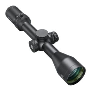 Black riflescope with adjustable turrets and large objective lens, photographed at an angle.