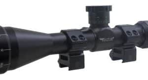 Black rifle scope with mounting rings and adjustment turrets on a white background, showing a long optical scope for aiming distances far away.