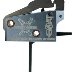 Close-up of a guitar bridge component: blue metal plate with two copper ferrules, engraved branding, screws, and a tuning lever visible on the right.