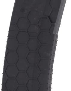 Black curved handgun magazine with a hexagonal honeycomb texture, red follower visible at the top.