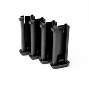 Four black handgun magazines standing upright in a row on a white background.