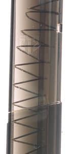 Lipstick with a red tip inside a dark brown translucent case, standing upright.