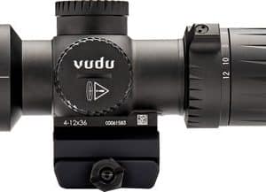 Close-up of a rifle scope with adjustment turrets and lens, mounted on a rail