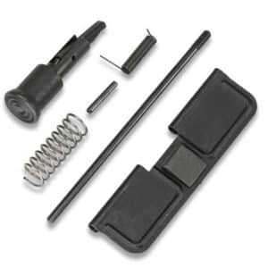 Assortment of small mechanical parts including a coiled spring, long rod, pins, and two black plastic housings laid out separately.