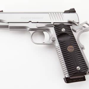 Close-up of a silver Wilson Combat handgun slide and black grip, showing the trigger and hammer details